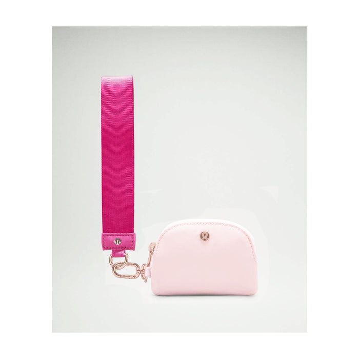 Top view of the pink wristlet showing two zippered pouches and rose gold zipper pulls