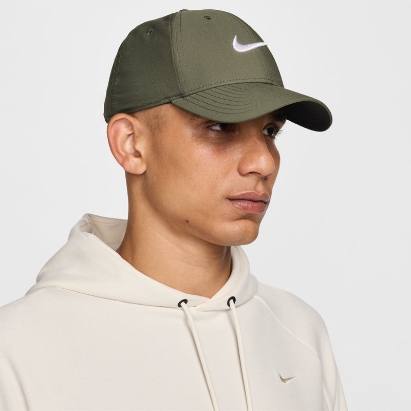 Nike medium olive cap with white Swoosh, curved brim profile view
