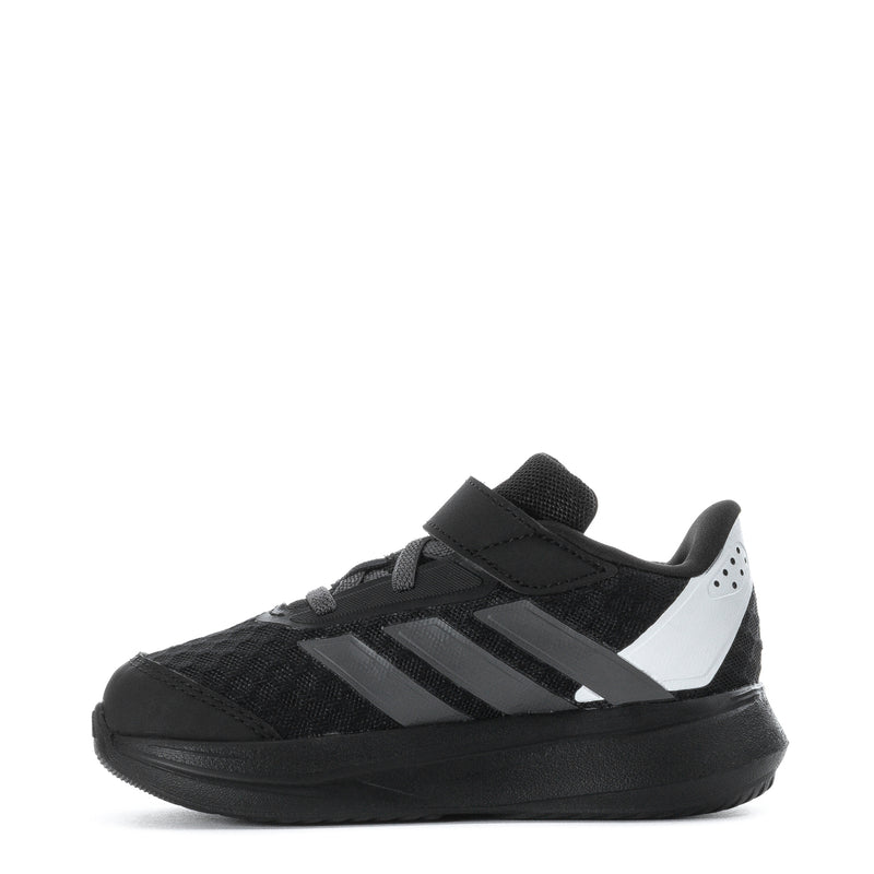 Kids black low-top sneaker, white accent panel, hook-and-loop strap, thick rubber sole