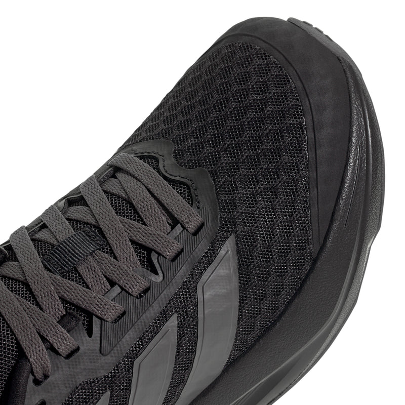 Youth running shoe close-up, black textured mesh upper with gray stripe overlays