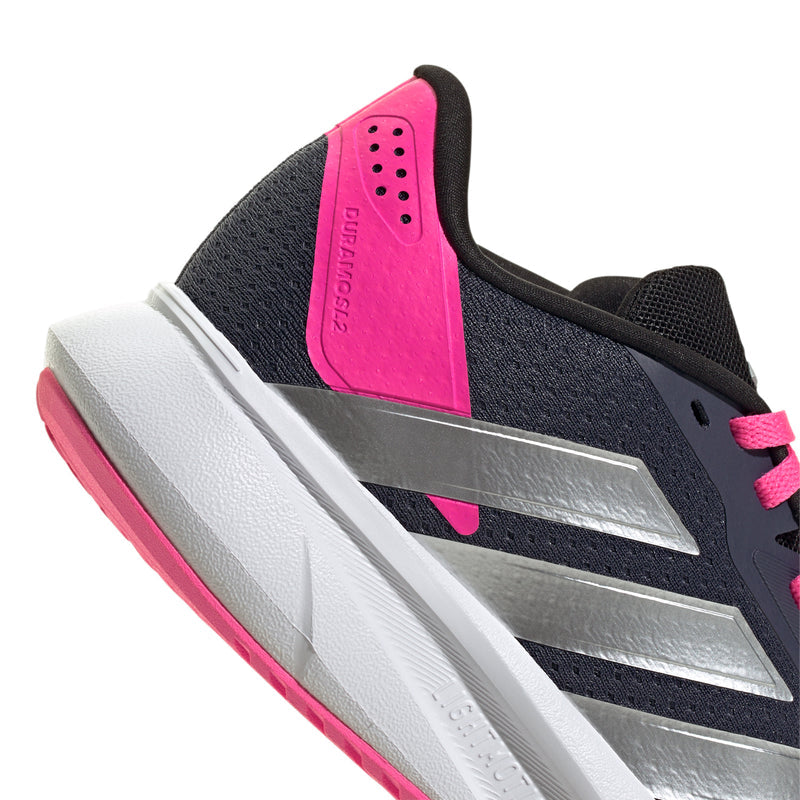 Navy youth running shoe side view with pink heel panel and silver support bar.