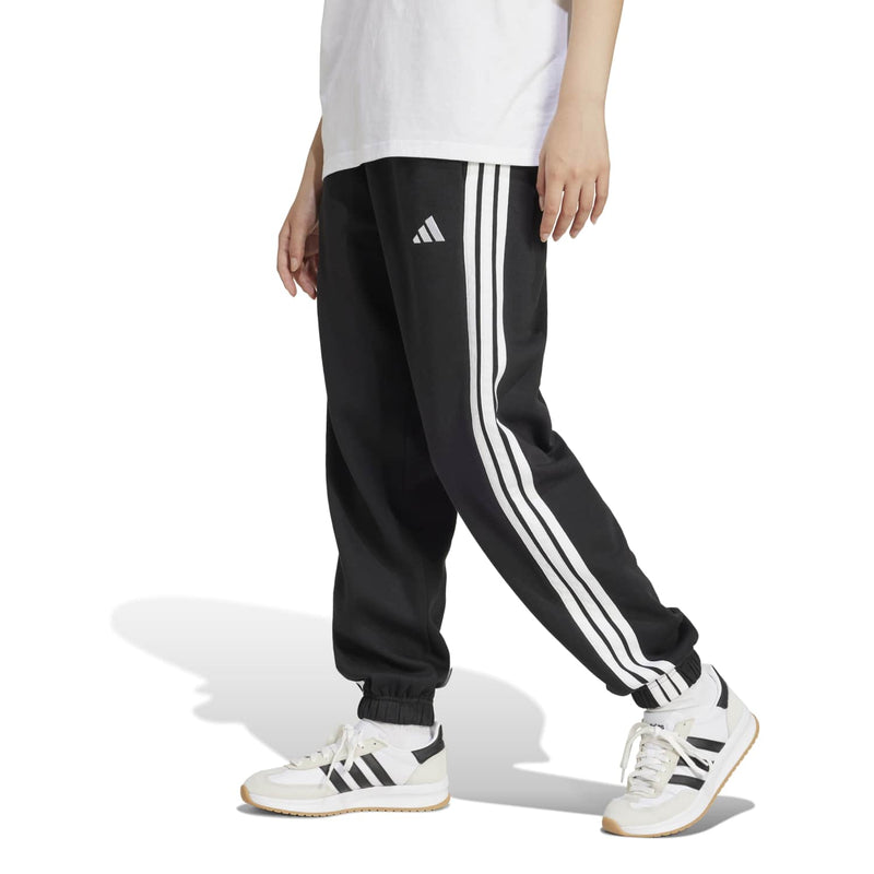Women’s black track pants with bold white side stripes, ribbed cuffs, adidas logo.