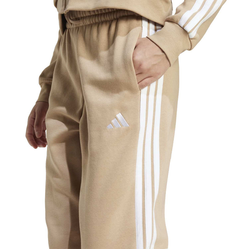 Warm sandstone jogger pants with white three-stripe logo and vertical side stripe panel