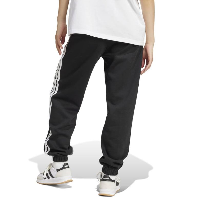 Women’s black track pants with white side stripes and ribbed ankle cuffs, back view.