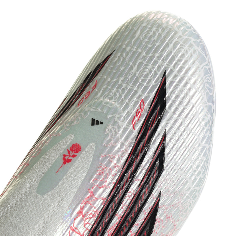 Close-up of men's white cleat upper with red rose pattern and black stripe panel