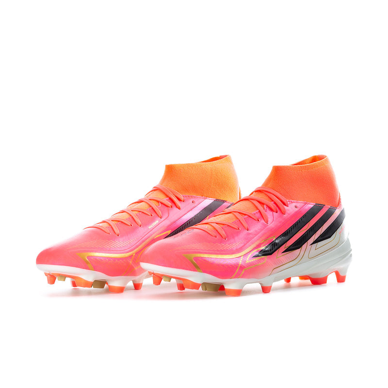 Men's mid soccer cleats with pink-orange upper, black stripes, white sole, and studded outsole