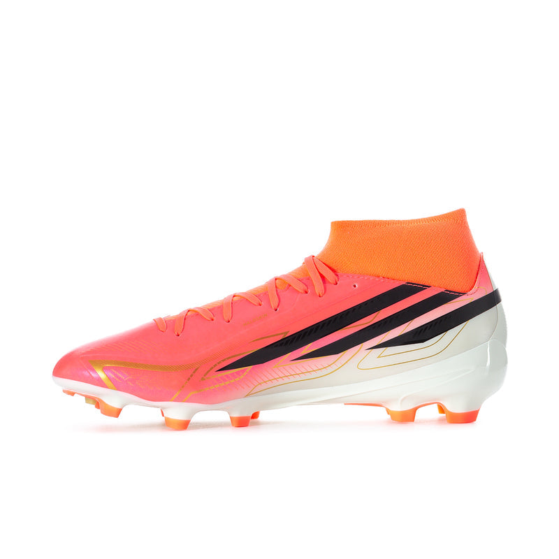 Men's mid soccer cleats side angle in pink-orange with black stripes and white stud sole