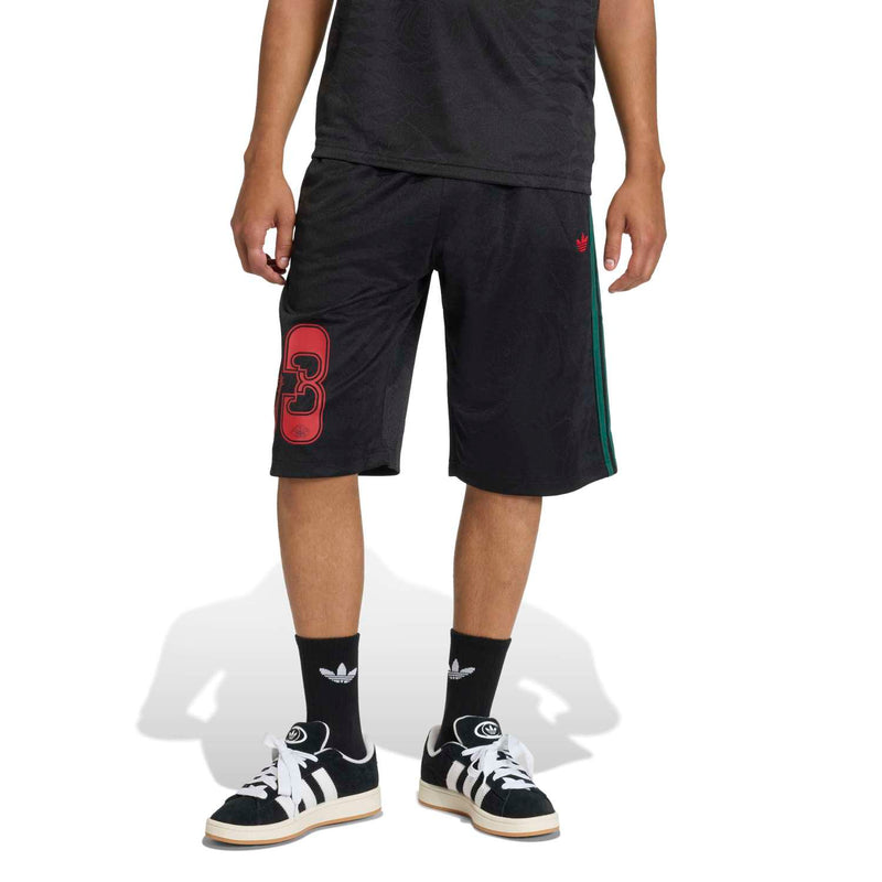 Men's black shorts from behind with red 83 graphic and green stripe on the side