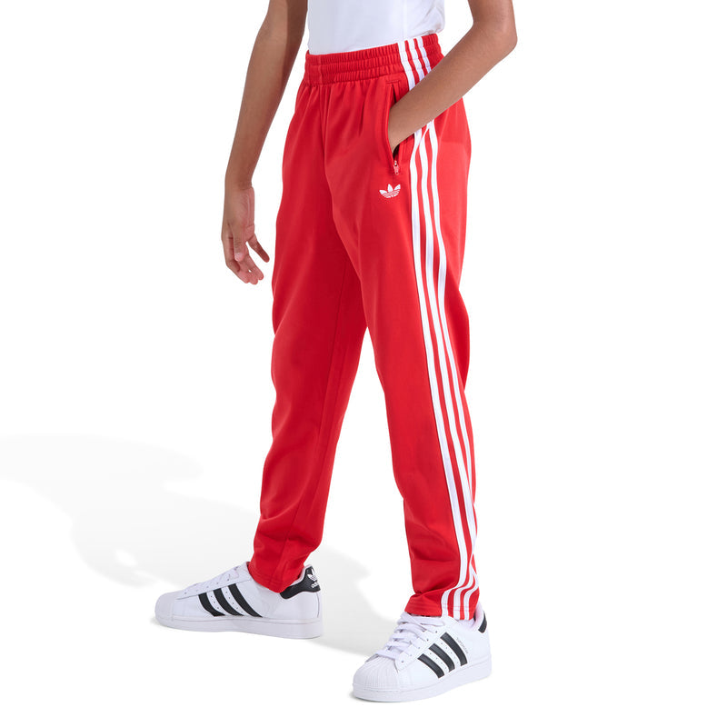 Youth red track pants with white side stripes and elastic ankle cuffs