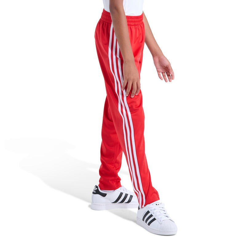 Youth red track pants with tall white side stripes and elastic waistband