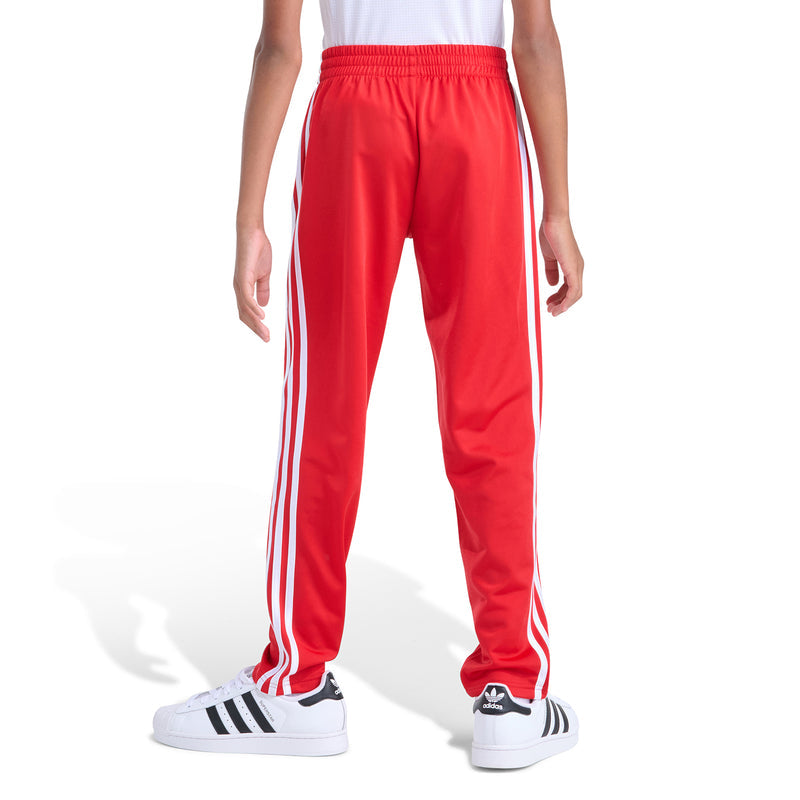 Youth red track pants with white side stripe accents and elastic waistband