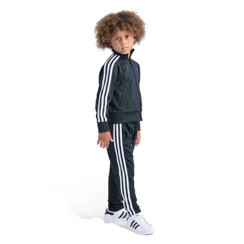 Kids black track set, side view: zip jacket with hood and matching striped pants.