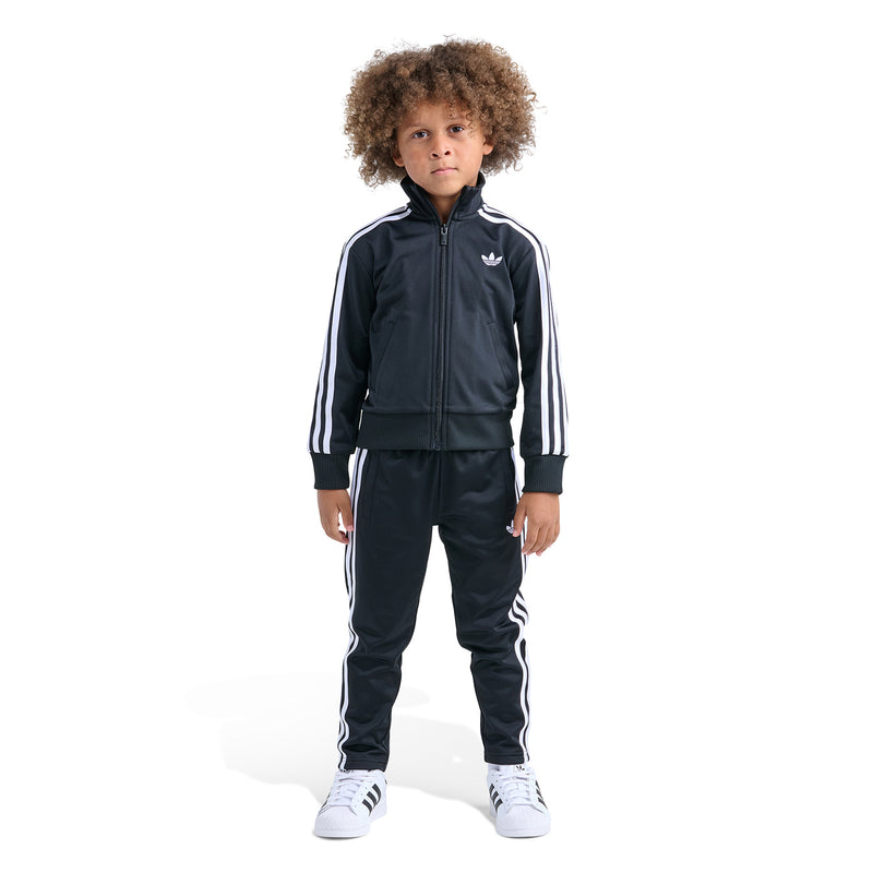 Kids black track set, front view: zip jacket and pants with white triple stripes.