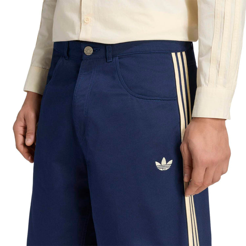 Men's navy twill jorts close-up with gold button, side triple stripes, trefoil