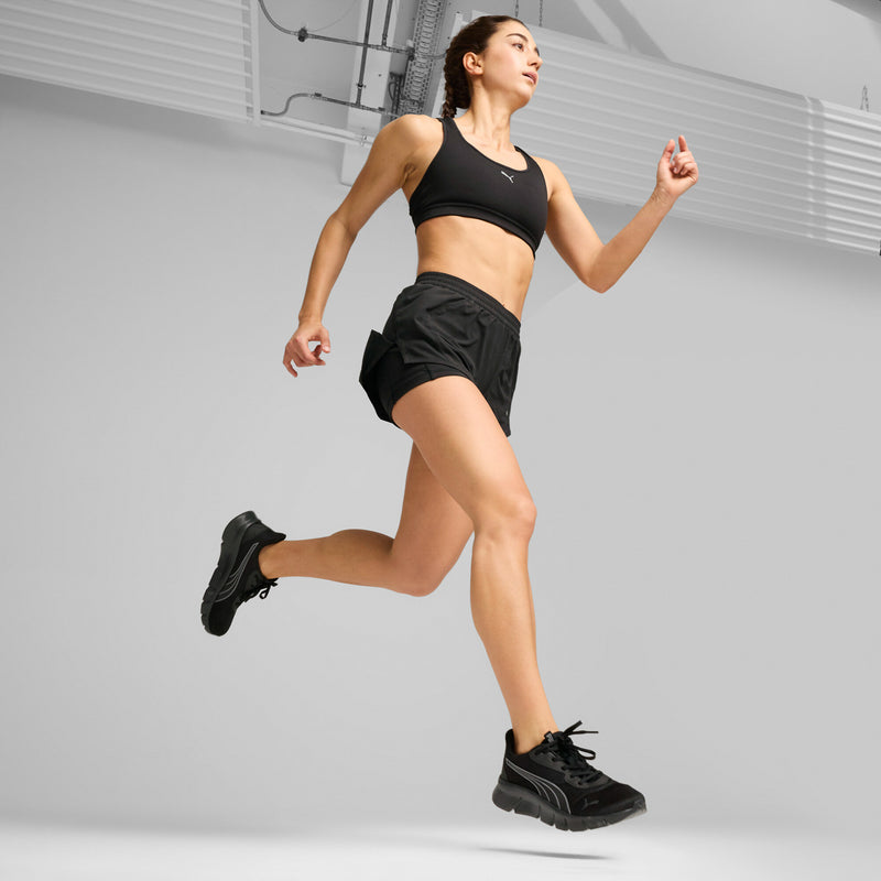 Men's black running shoes mid-stride with lace-up front and cushioned tread sole