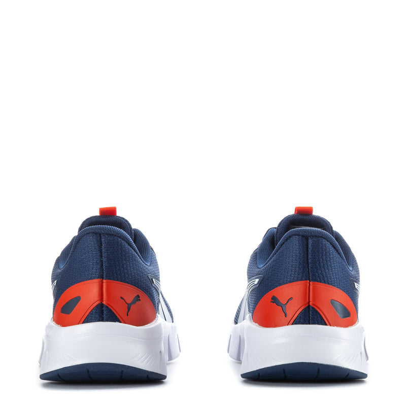 Youth navy sneakers with orange heel stripe and white sole, rear view, Puma