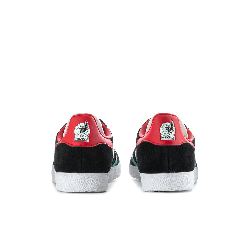 Black men's sneakers with red heel tab, green side stripe, white rubber sole