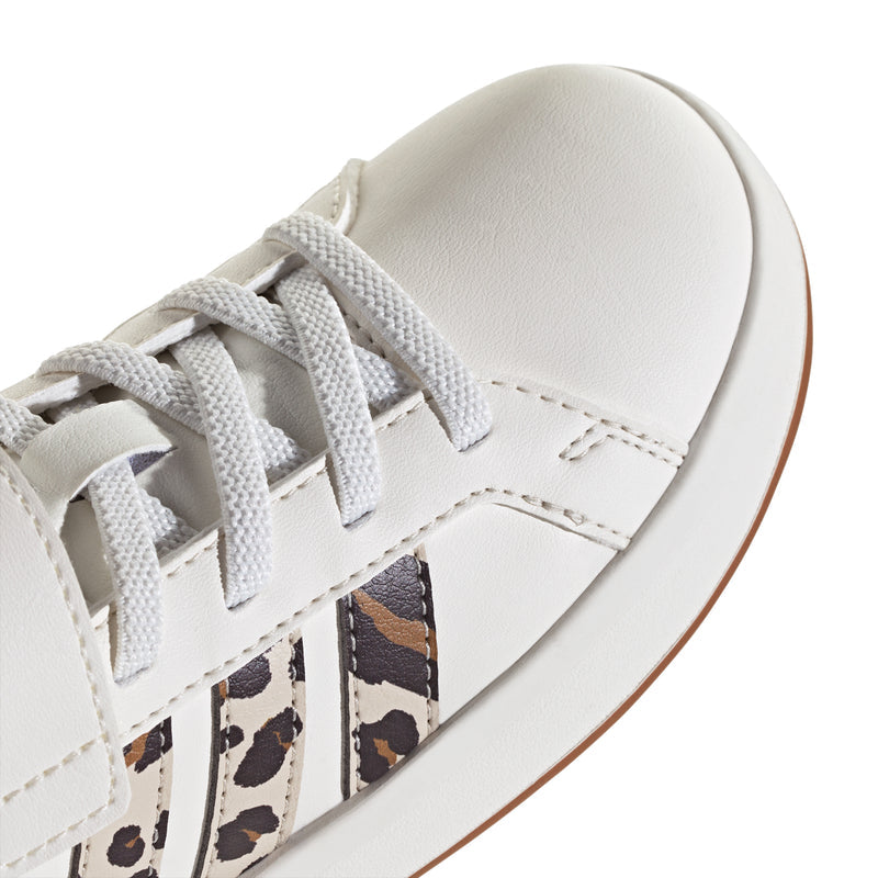 Close-up of kids adidas Grand Court sneaker upper: white laces with leopard stripe panel