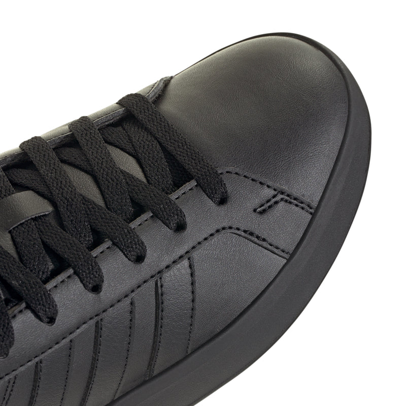 Black leather-look adidas sneaker toe and lace area close-up
