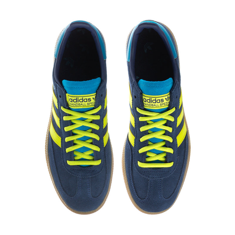Pair of men's sneakers with neon laces, navy upper, teal lining, and branding