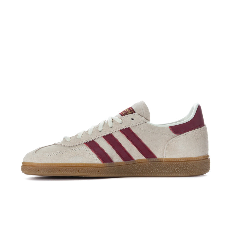Side view of beige lace-up sneakers with burgundy stripes and gum sole
