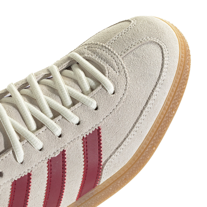 Beige suede toe cap with white laces, burgundy stripes, and textured gum sidewall
