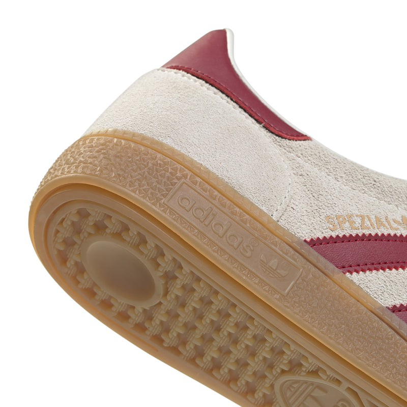 Beige sneaker sole and sidewall close-up with gum tread and burgundy heel panel