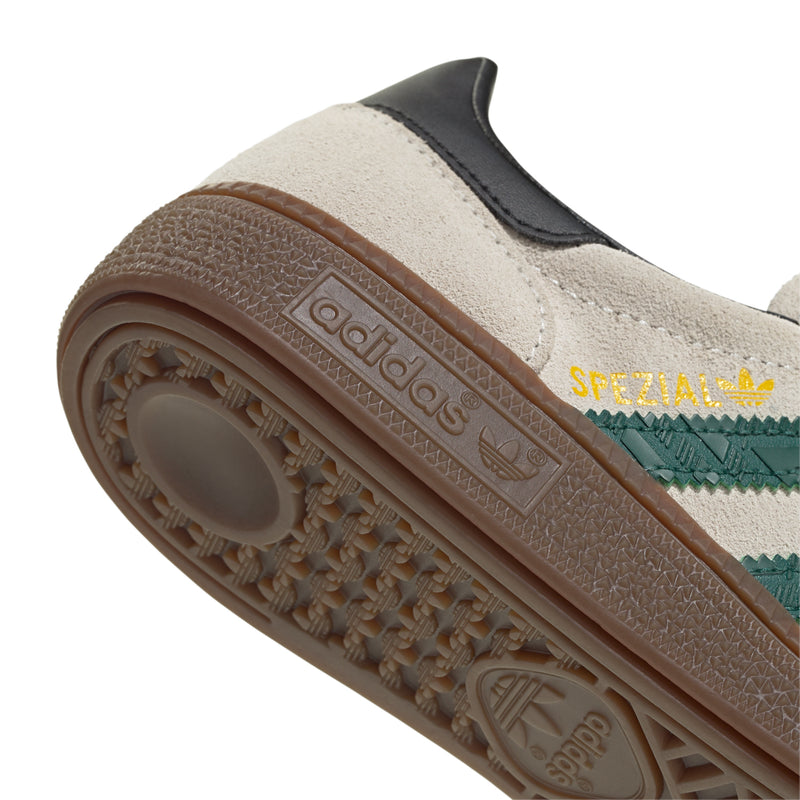 Youth sneaker outsole close-up, gum tread with adidas and Spezial branding