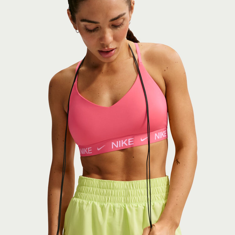 Coral pink sports bra with thin straps and Nike logo elastic band