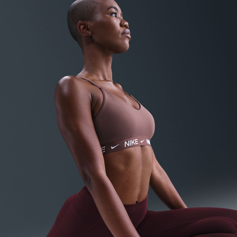 Mauve sports bra with racerback straps and Nike logo elastic band
