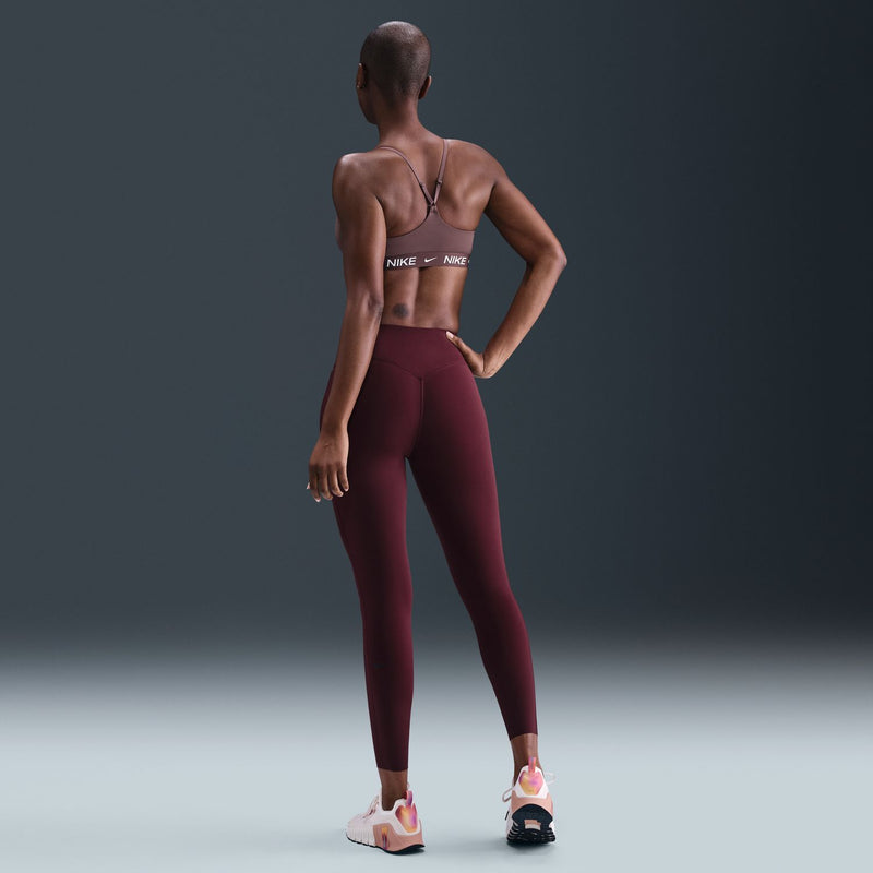 Mauve sports bra with racerback design and Nike logo elastic band