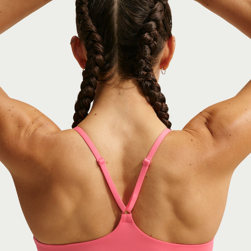 Coral pink sports bra back with crossed straps and V-shaped neckline
