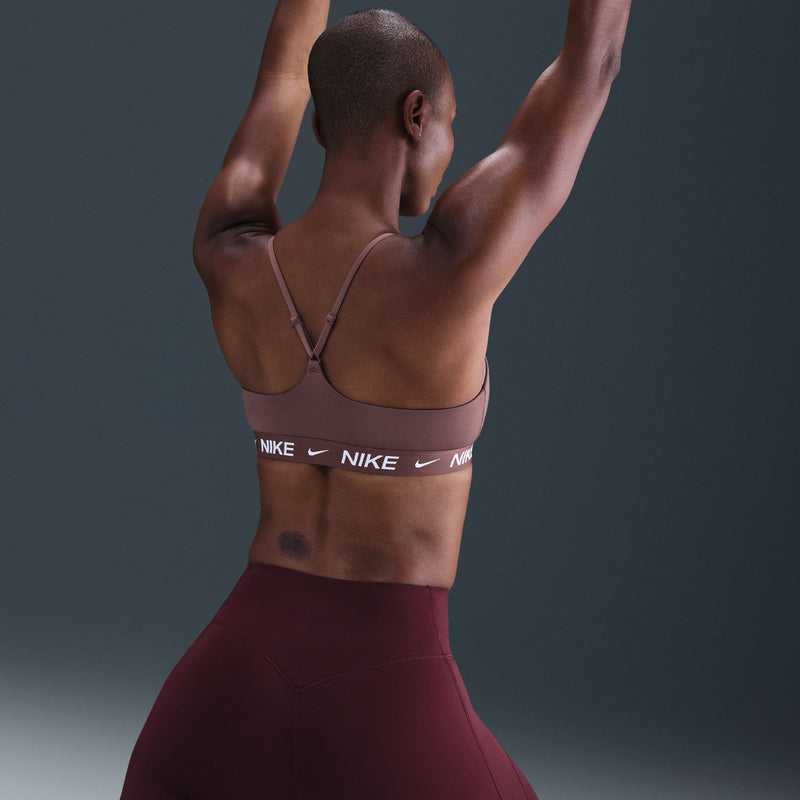 Mauve sports bra with crisscross back straps and Nike logo elastic band
