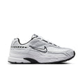 White women's Nike Initiator sneakers with black accents, lace-up front, padded sole.