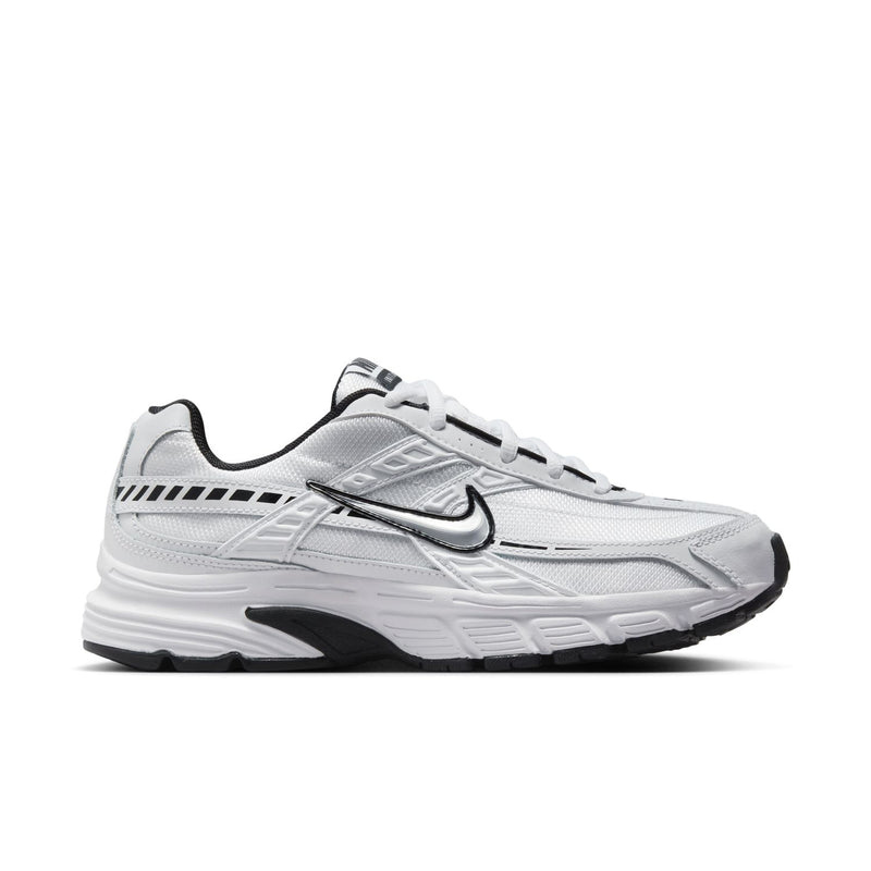 White women's Nike Initiator sneakers with black accents, lace-up front, padded sole.