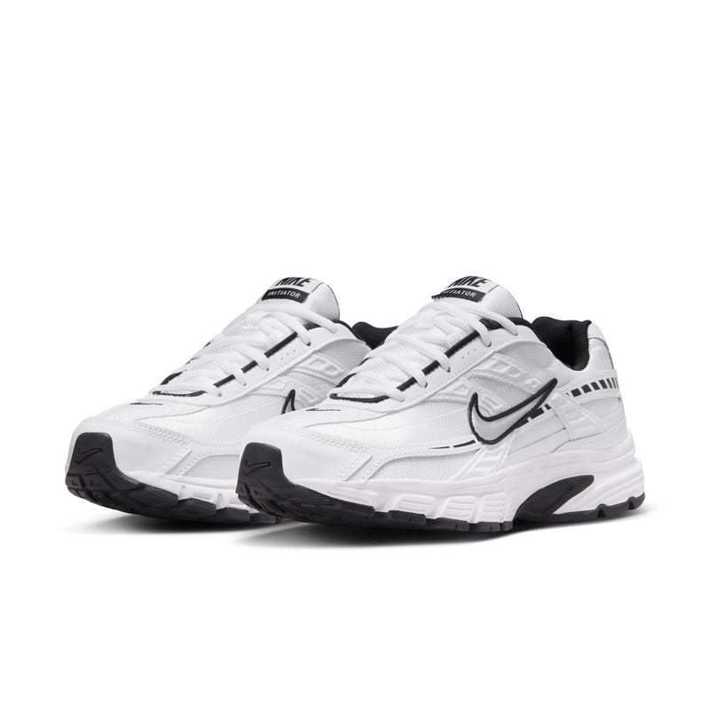 White women's Nike Initiator sneakers, side-by-side angle, black heel and swoosh details.