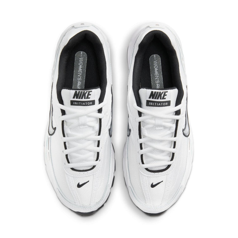Pair of white Nike Initiator sneakers with black-lined tongue and lace-up closure.