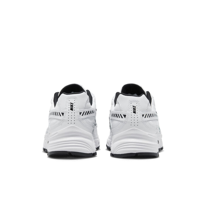 Back view of white Nike Initiator sneakers with black heel tabs and cushioned sole.