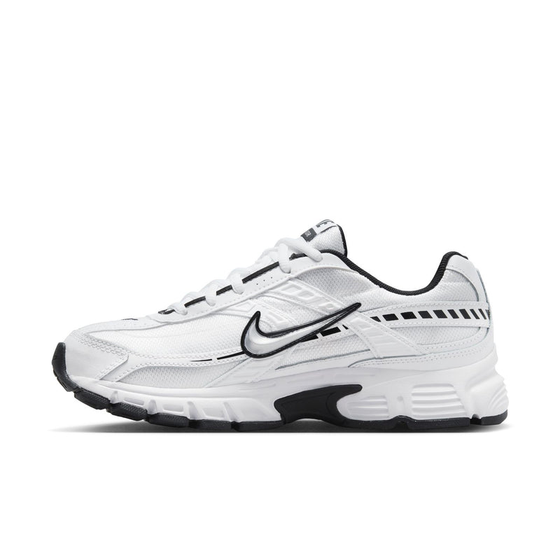 White Nike Initiator lace-up sneakers with black trim, cushioned midsole, swoosh logo.