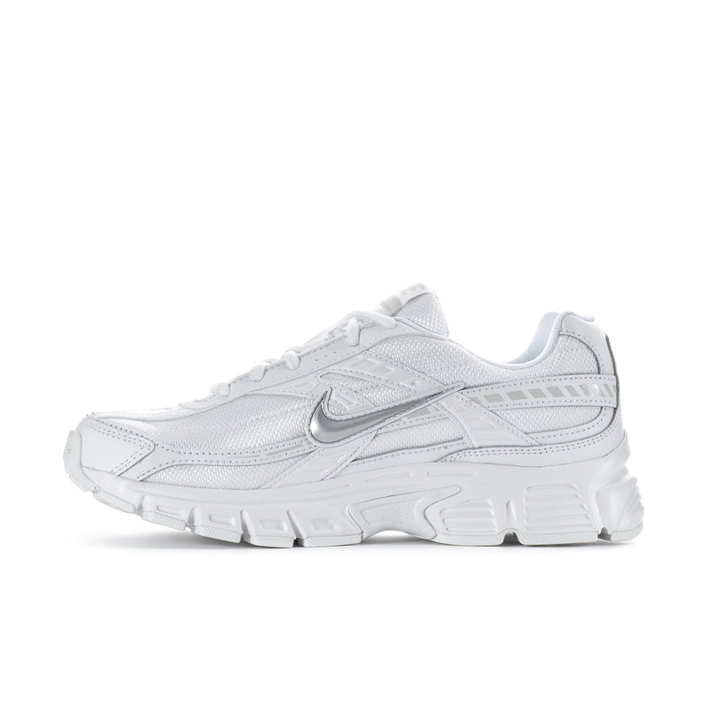 White women's athletic sneaker side view with Swoosh and layered panels