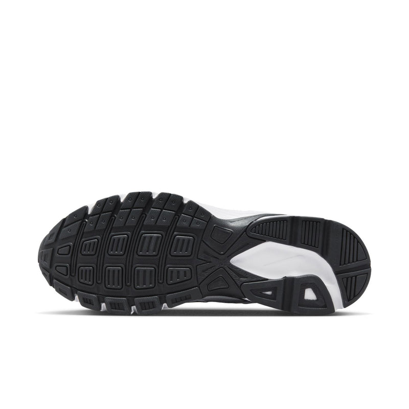 Black rubber outsole of white Nike Initiator sneakers with deep traction tread.