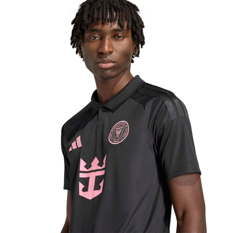Men's black soccer jersey close-up with pink crest and Adidas logo