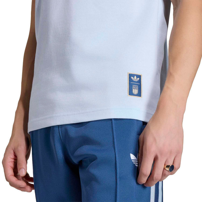 Light blue men’s T-shirt hem close-up with small Italy crest patch