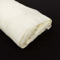 Rolled white fabric on a black background.