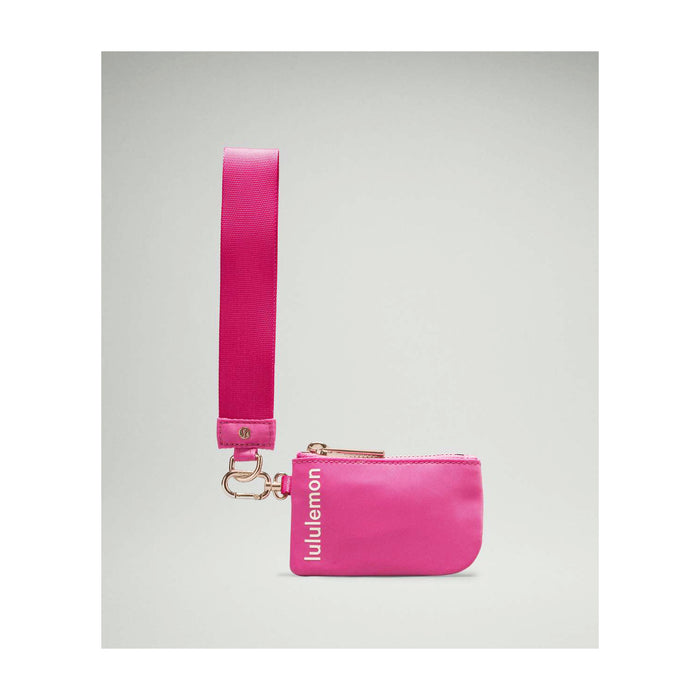 Close-up of embroidered Pi Beta Phi letters in light pink on a vibrant pink wristlet