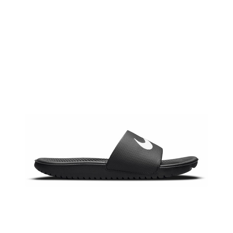 Youth black slide sandals with white Nike swoosh, textured footbed and sole