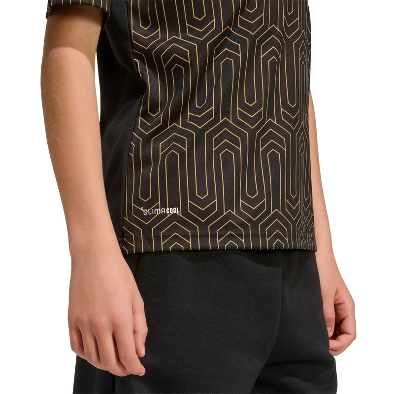 Youth black soccer jersey with gold geometric pattern and plain black lower section