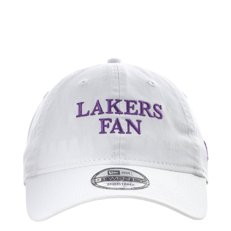 White baseball cap with purple “LAKERS FAN” front text and curved brim