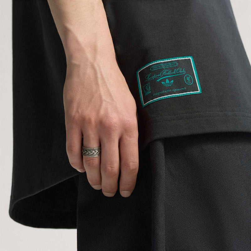 Men’s black Liverpool icon T-shirt close-up with teal rectangular sleeve hem tag