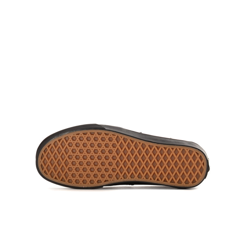 Youth black Vans loafer outsole with brown diamond-pattern tread